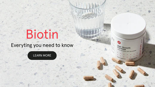 Biotin, everything you need to know. Image banner shows the Hair Growth Formula and a glass of water on top of a table with the tablets scattered around it.