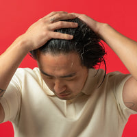 Image showing a man applying conditioner on his hair.