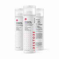 Image showing three bottles of the REVIVE Thickening Conditioner.