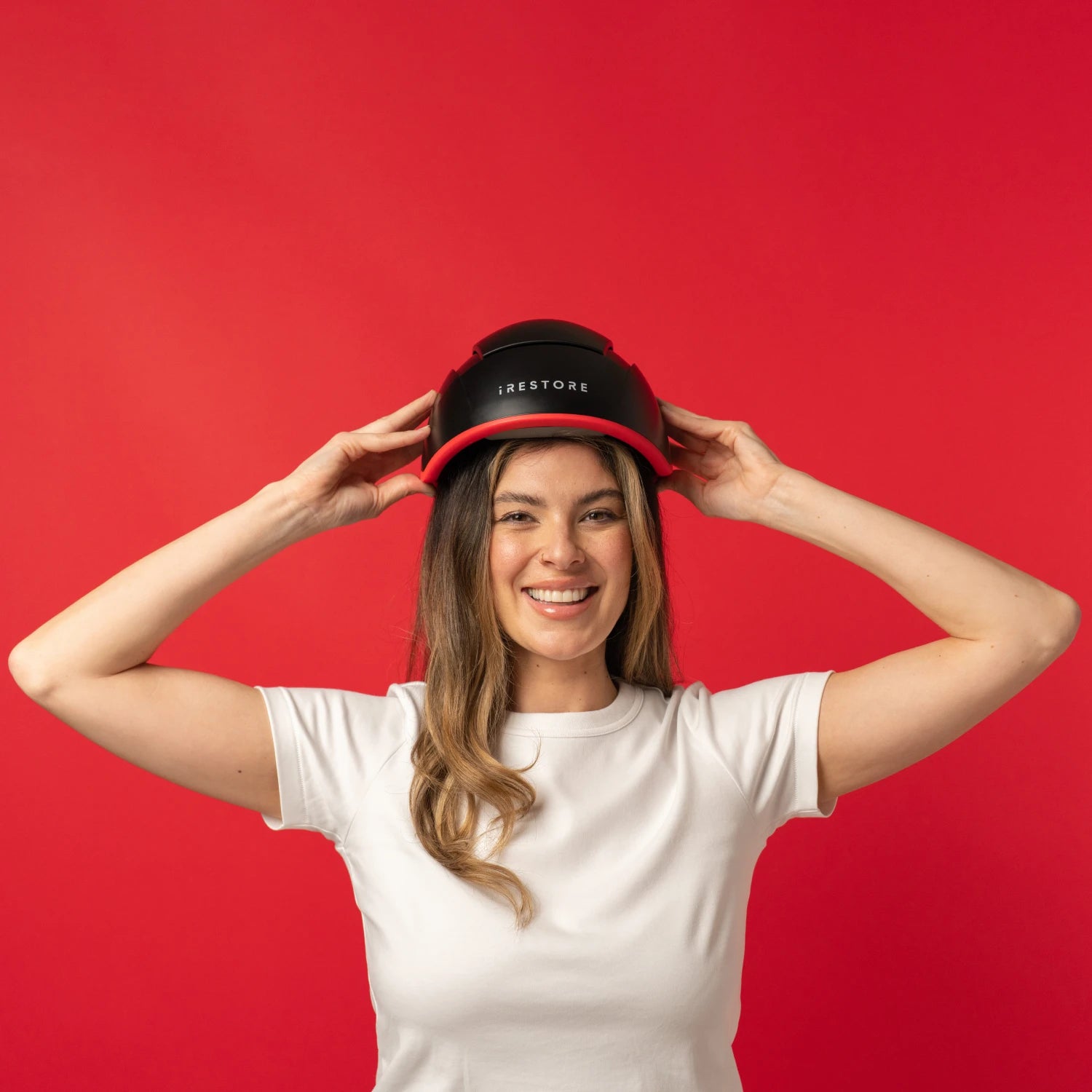 Image of a middle aged woman wearing the Elite hair device.