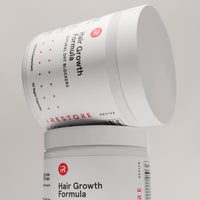 hair growth formula bottle on top of hair growth formula bottle