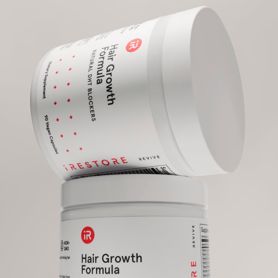 hair growth formula bottle on top of hair growth formula bottle