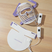 iRESTORE ED face mask and iRESTORE LED neck and chest mask with remotes on top of a table