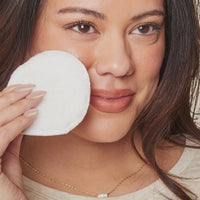 woman showcasing and applying the eyelash enhancing serum