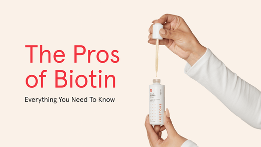 The Pros of Biotin. Everything you need to know. Image banner shows a close up shot of two hands holding the Growth Activator Serum bottle in one hand and on the other hand holding the dropper while dispensing the serum into the bottle. 