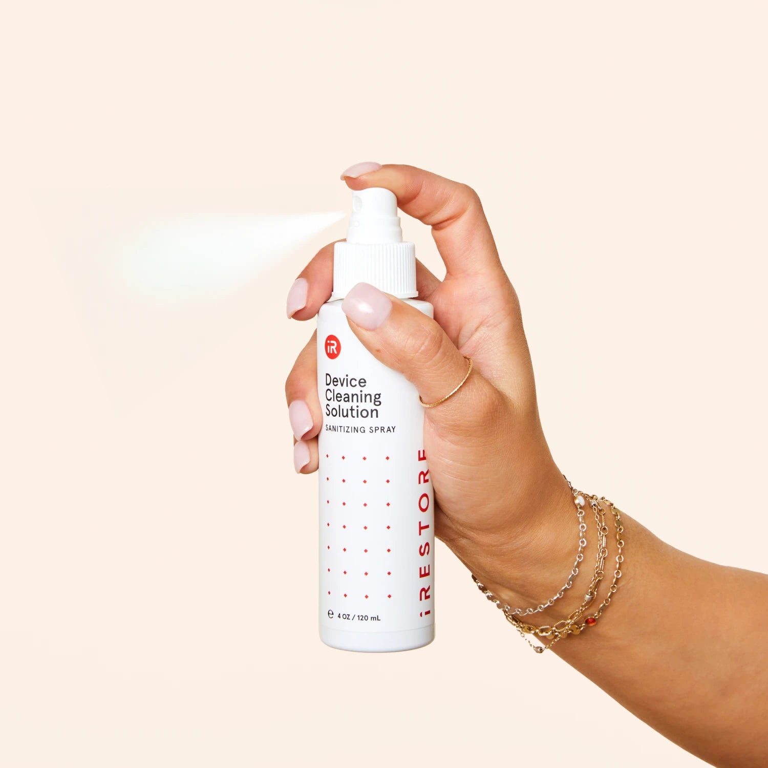 Close up shot image of a hand holding the Device Cleaning Solution.