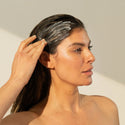 Image of woman lathering her hair with thickening conditioner