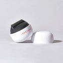 Image of the ScalpStim Derma Roller placed on top of a table with its cap beside it.