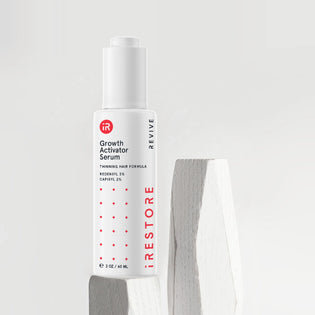 Growth activator serum on top of white wood