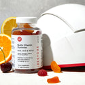 Biotin vitamin gummies with irestore professional device behind it.