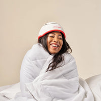 Image of a middle aged woman wearing the Professional hair device in her bed.