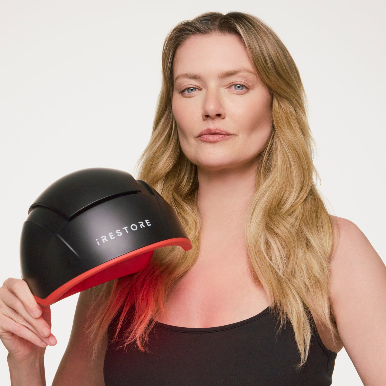 woman holding the Elite hair device.