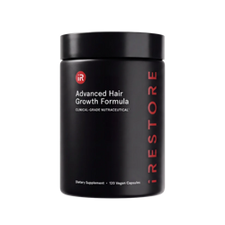 A black cylindrical supplement jar labeled 'iRESTORE Advanced Hair Growth Formula' on a plain white background.