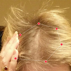 Top down view after image of a woman showing the frontal region of her hair with thicker hair.