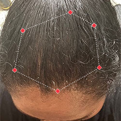 Top down view after image of a woman with thicker hair at the frontal region of her hair.