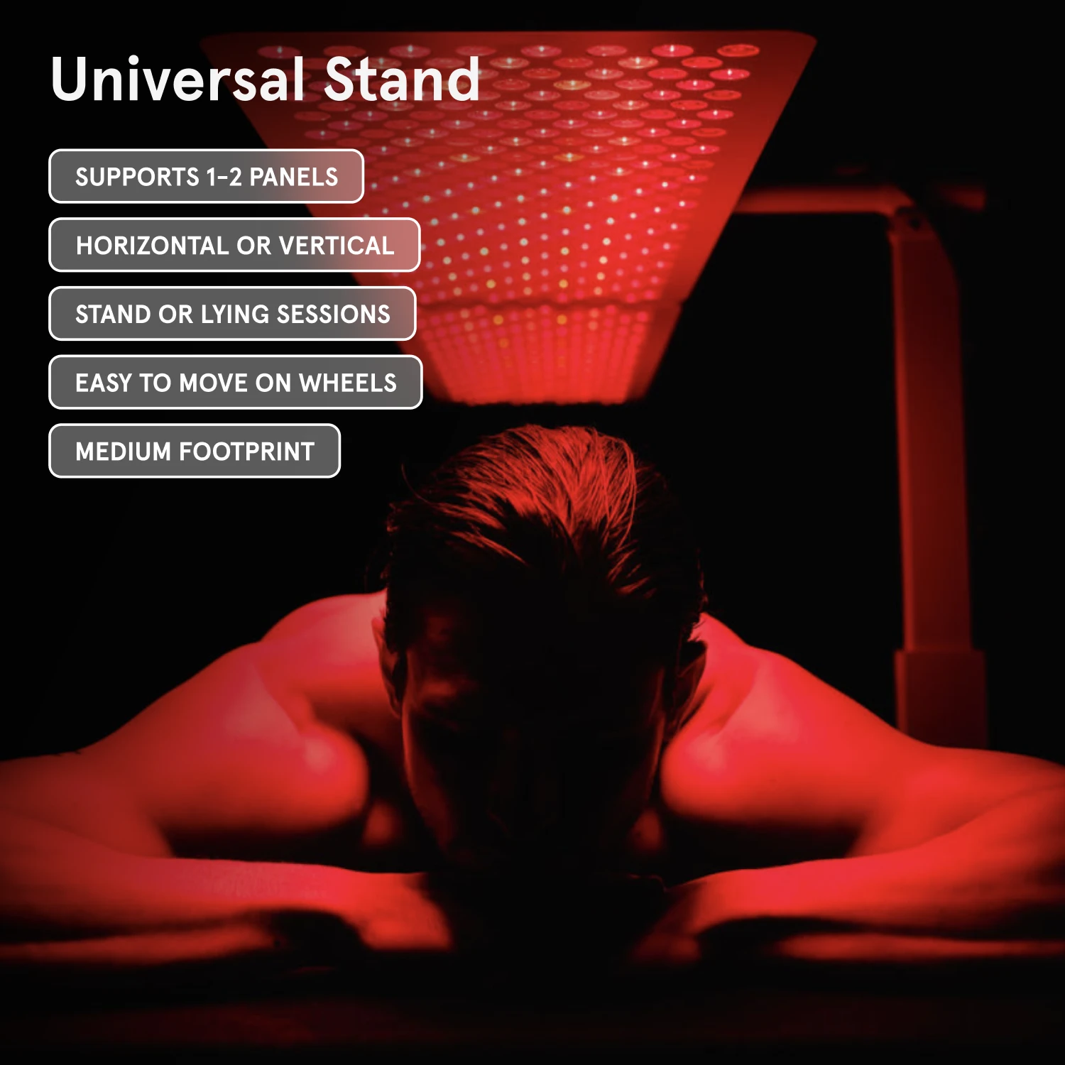 Person lying under a red light therapy panel with text describing the 'Universal Stand'.