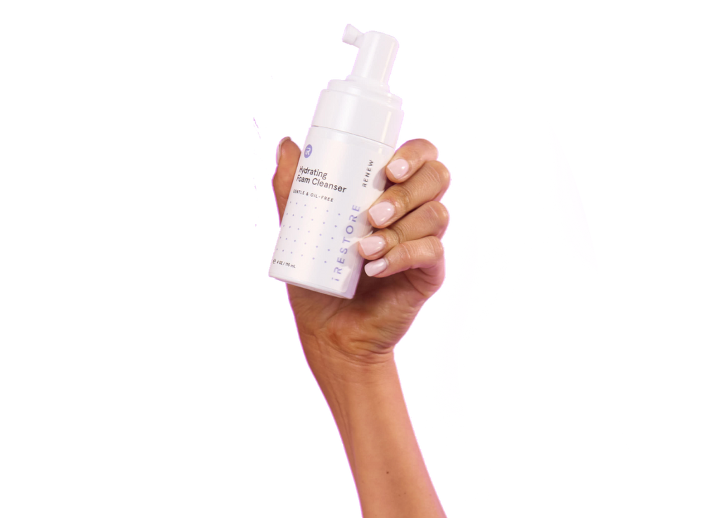 Hand holding the hydrating foam cleanser