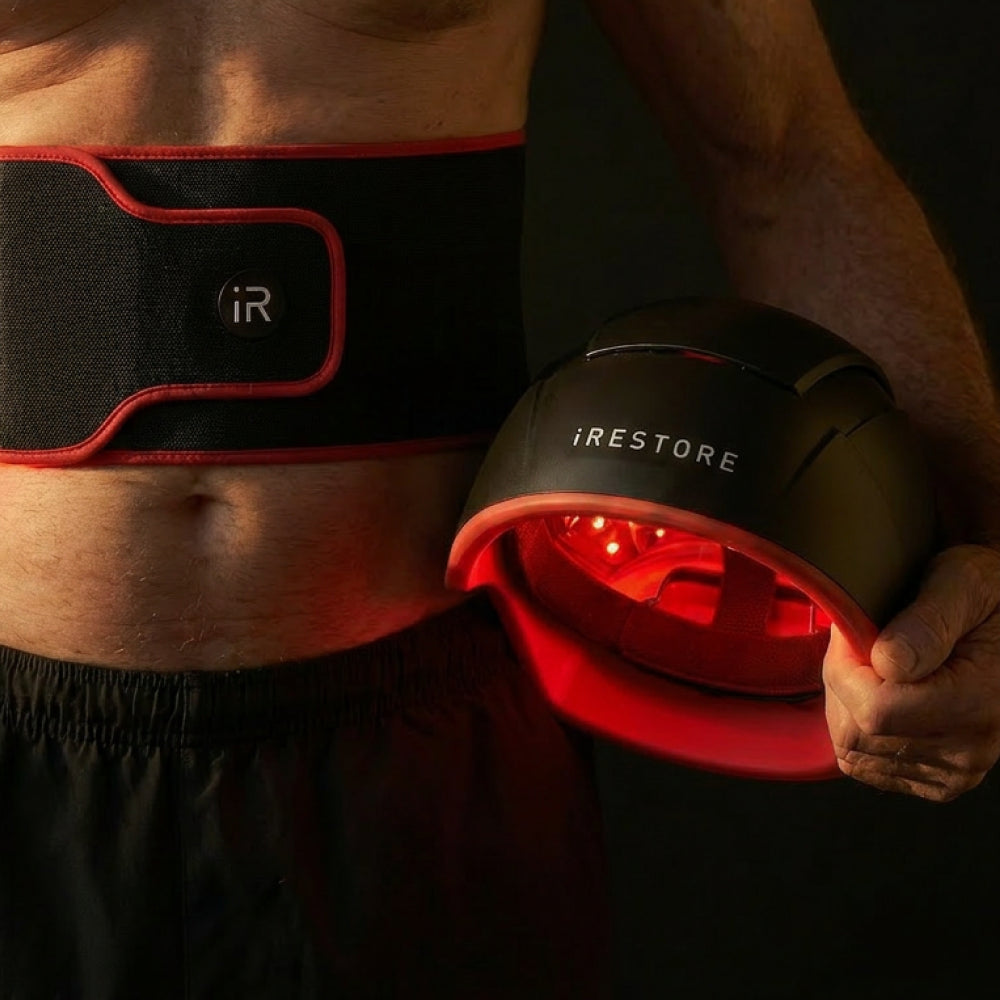 Man holding irestore elite and wearing sculpt belt