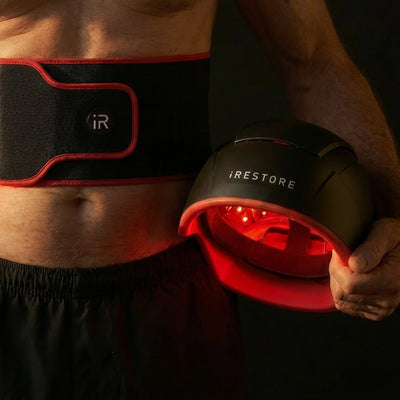 Man holding irestore elite and wearing sculpt belt