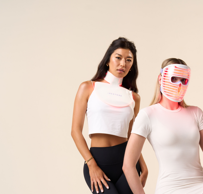 Woman wearing LED Neck and Chest mask standing beside a woman wearing LED face mask