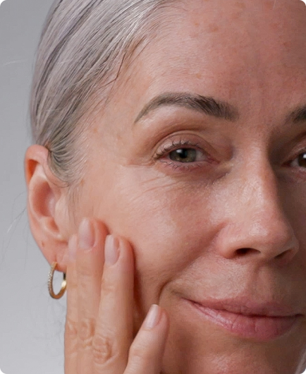Mature woman touching her cheek