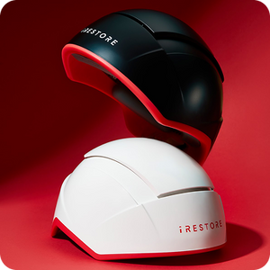 Black and white hair restoration device with 'iRestore' branding on a red background