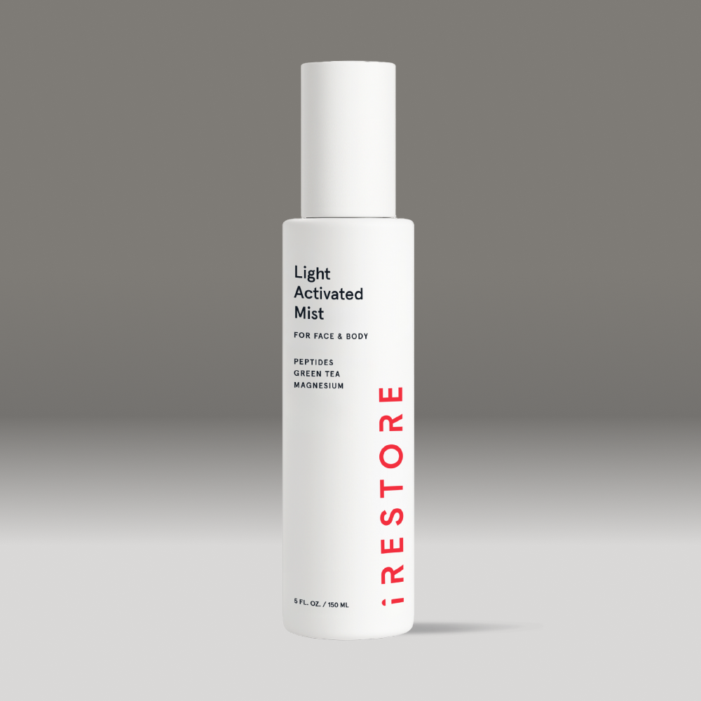 White bottle of light activated mist on a gray background