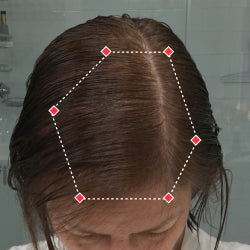 Top down view after image of a woman with thicker hair at the frontal region of her hair.