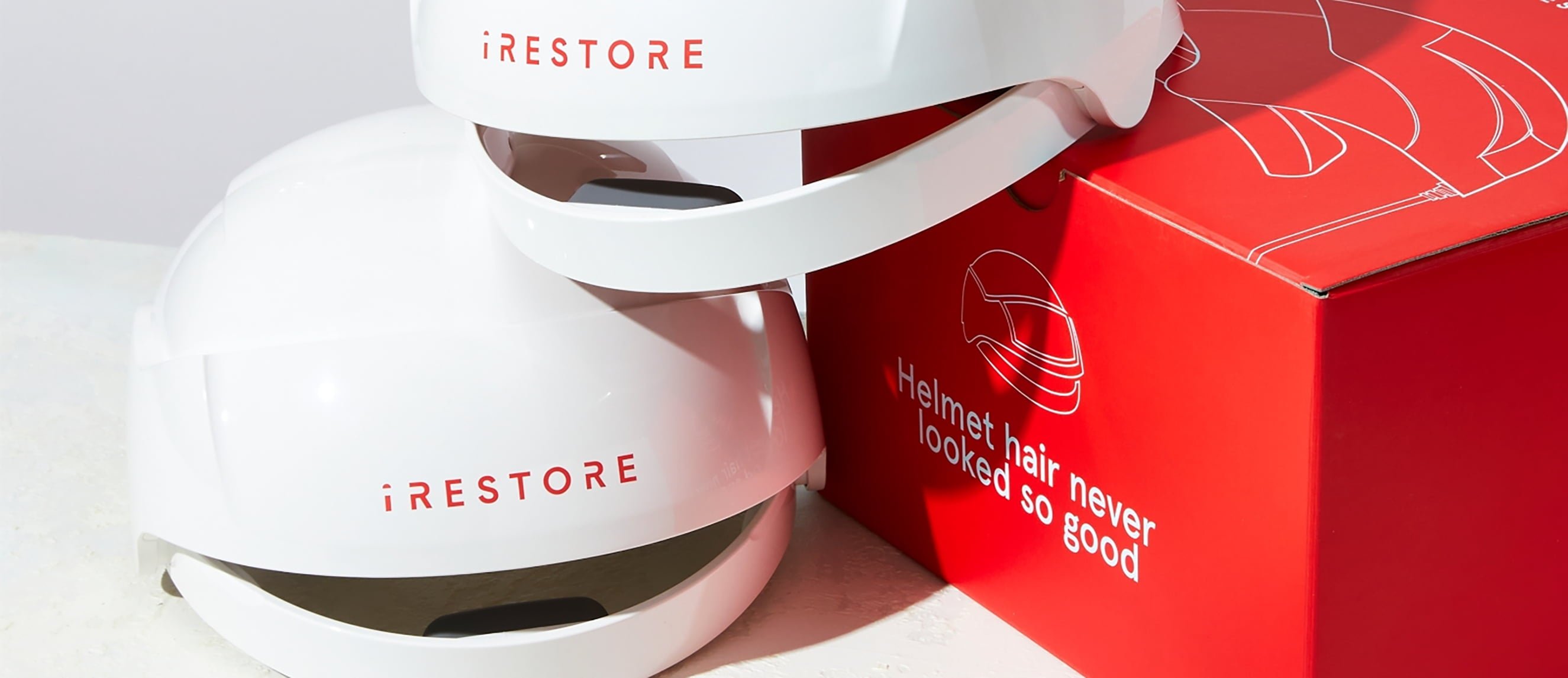 Image of two Essential Device on top of each other with the packaging box beside it.