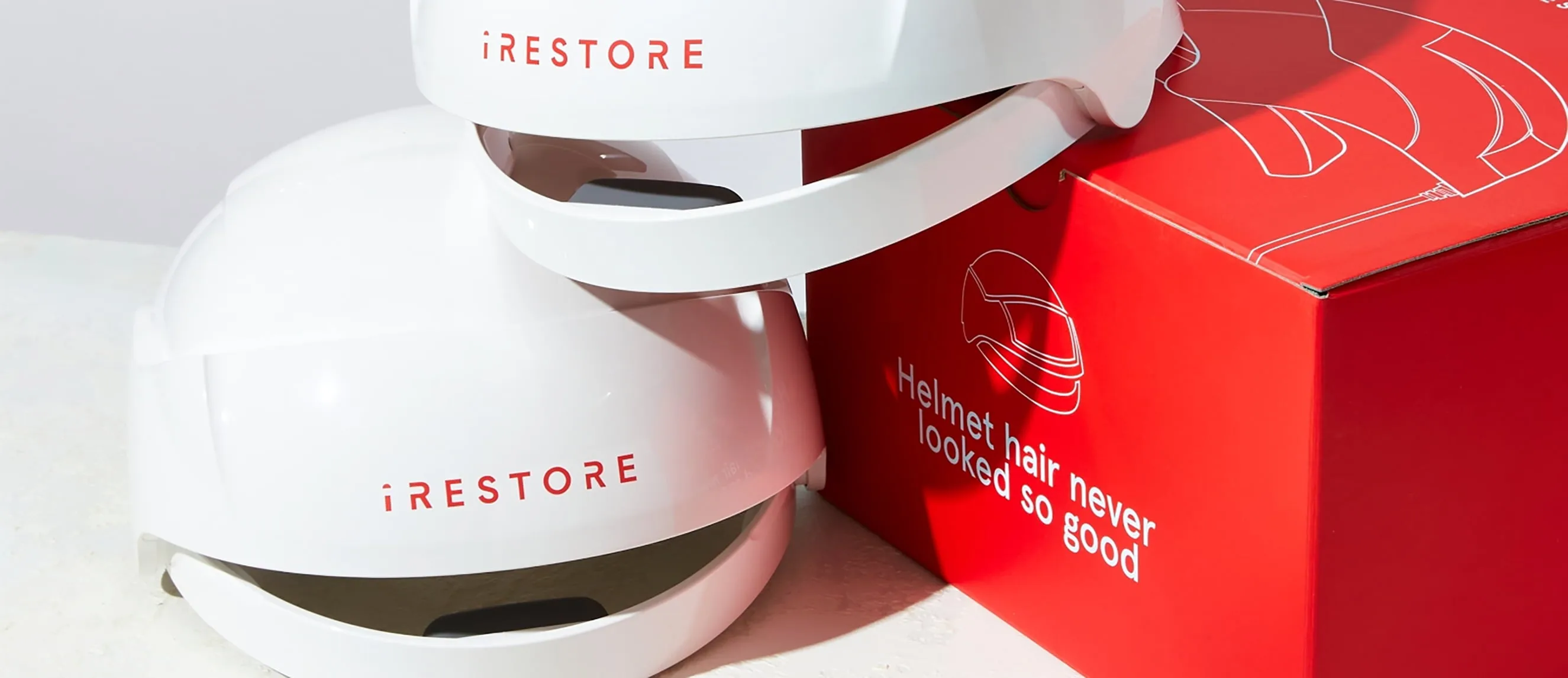 Image of two Essential Device on top of each other with the packaging box beside it.
