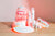 LED face mask, LED neck and chest mask, LED eye mask, Calming facial spray, Hydrating foam cleanser, Anti-aging face serum, and Anti-aging eye cream on top of a wooden table