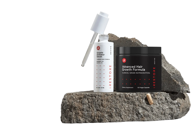 Image showing the REVIVE+ Growth Accelerator Kit place on top of a rock.