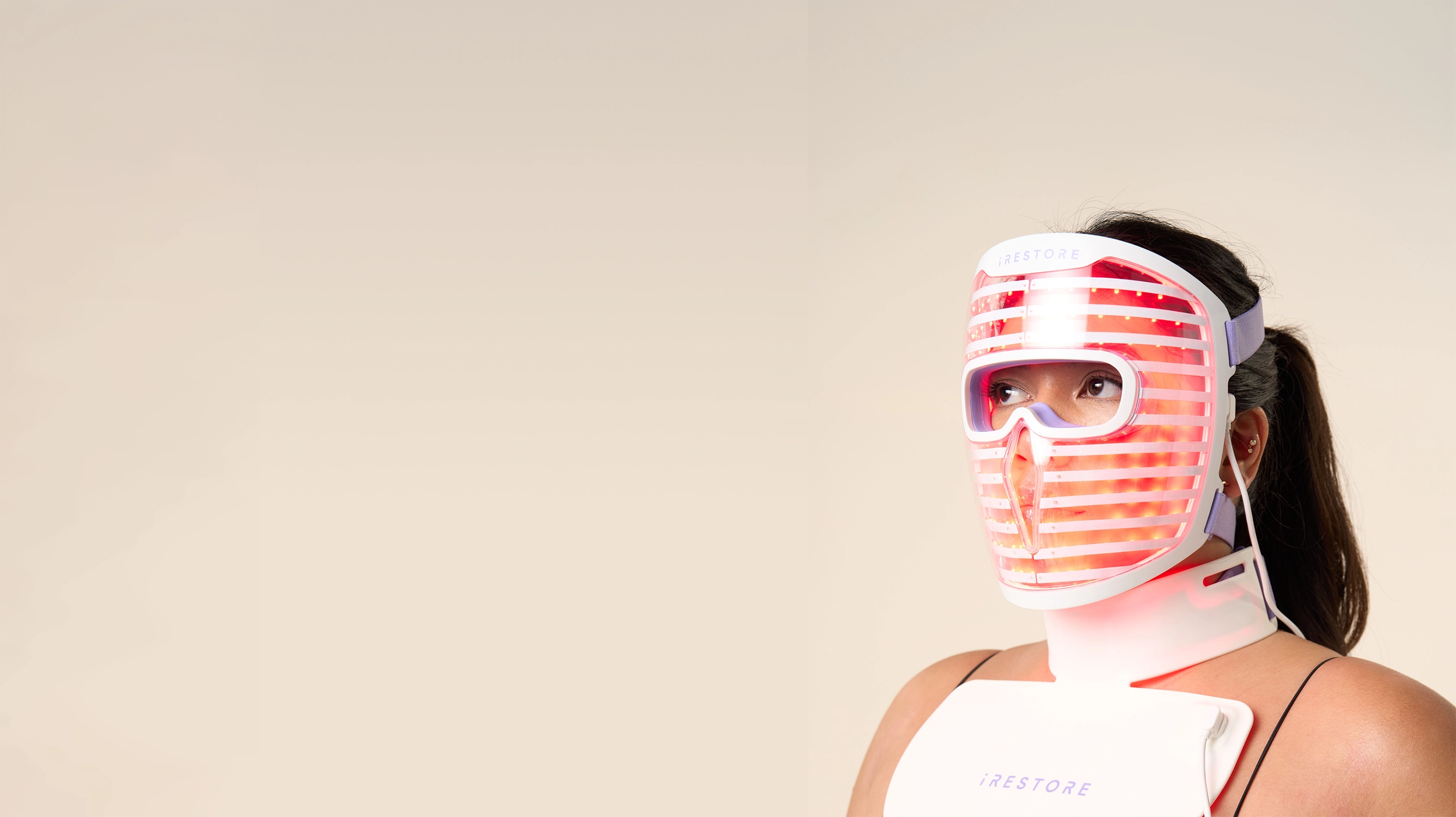 Woman wearing the iRESTORE face mask and neck and chest mask
