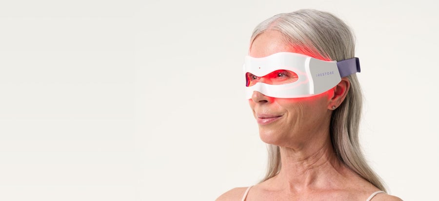 Close up shot of woman wearing LED eye mask