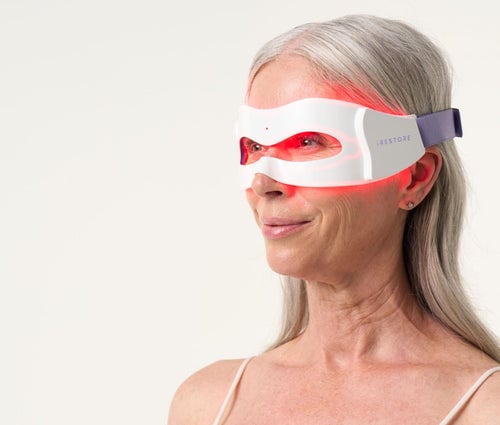 Close up shot of woman wearing LED eye mask