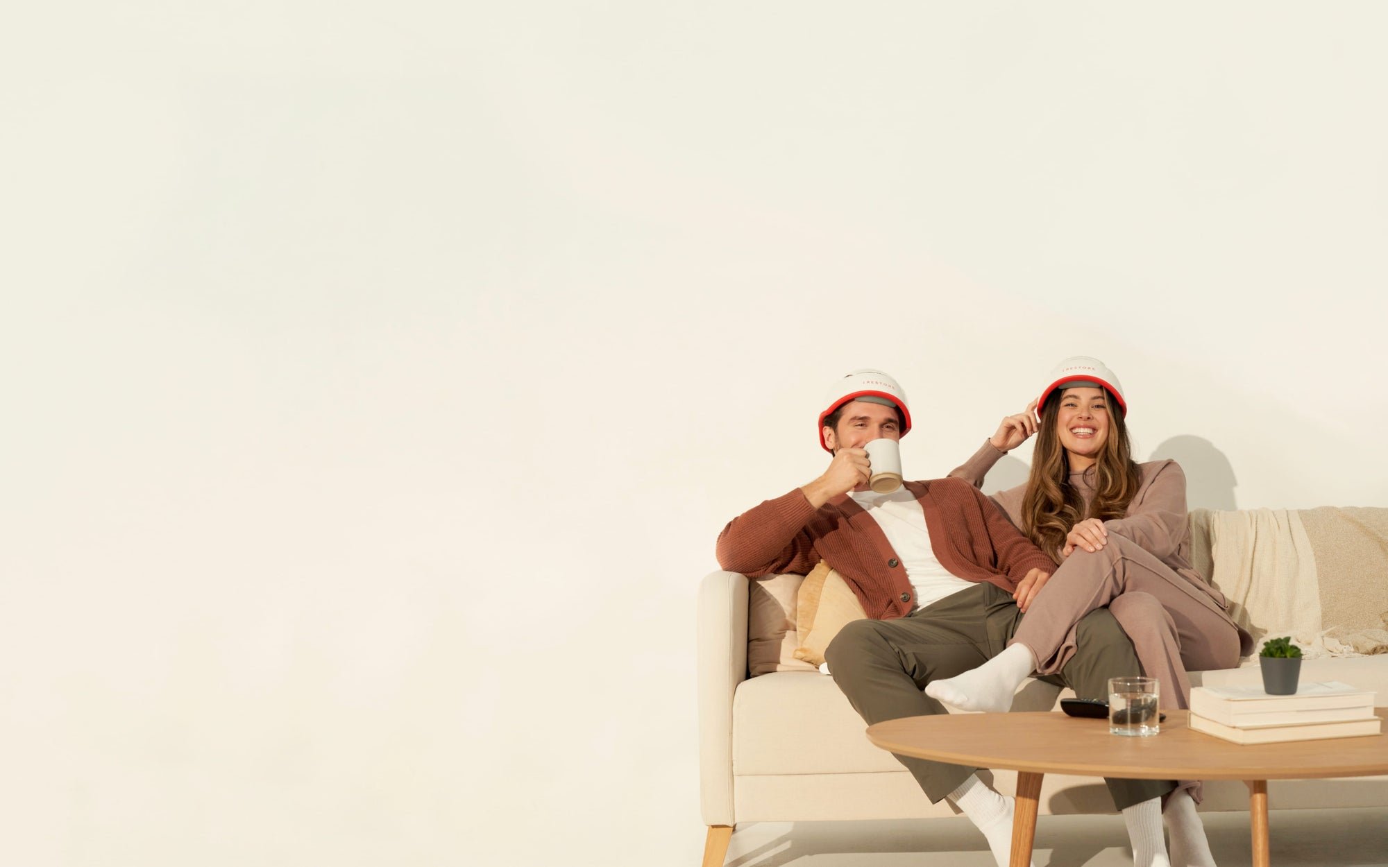 Image of a man and woman sitting on a couch, wearing the Professional hair device.