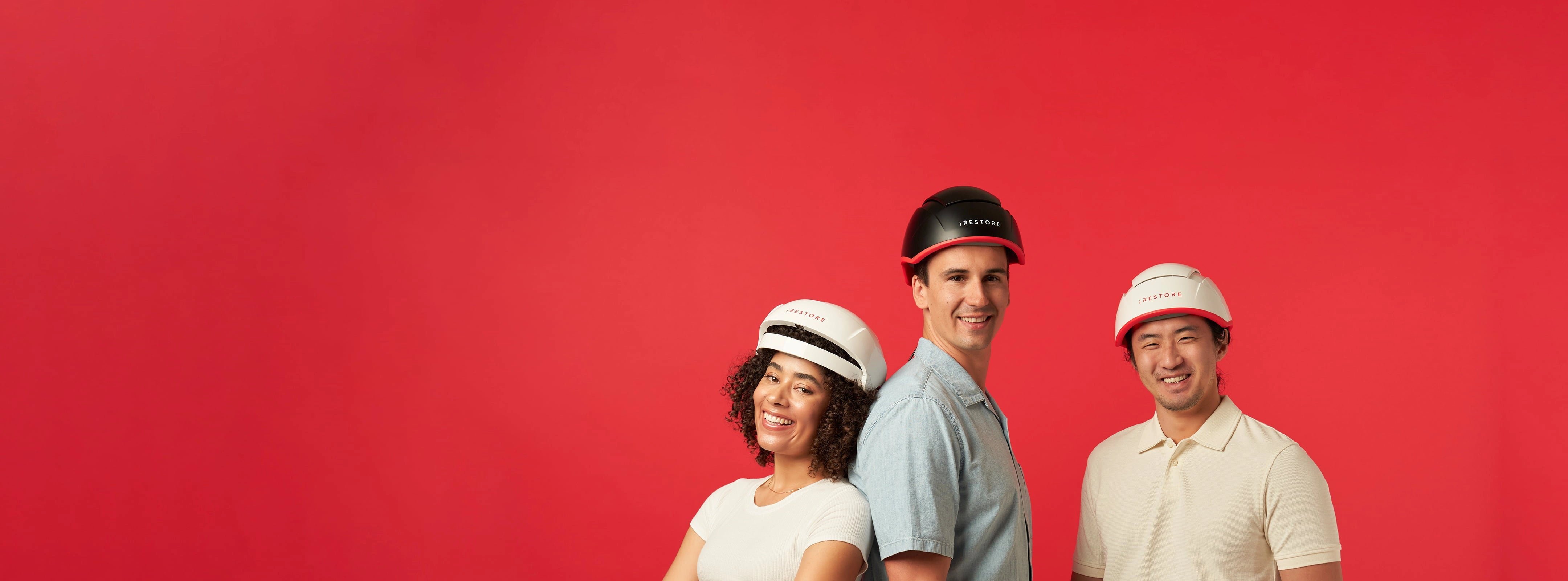 Woman wearing the Essential Hair Device standing beside two men, one wearing the Elite Hair Device while the other one wearing the Professional Hair Device.