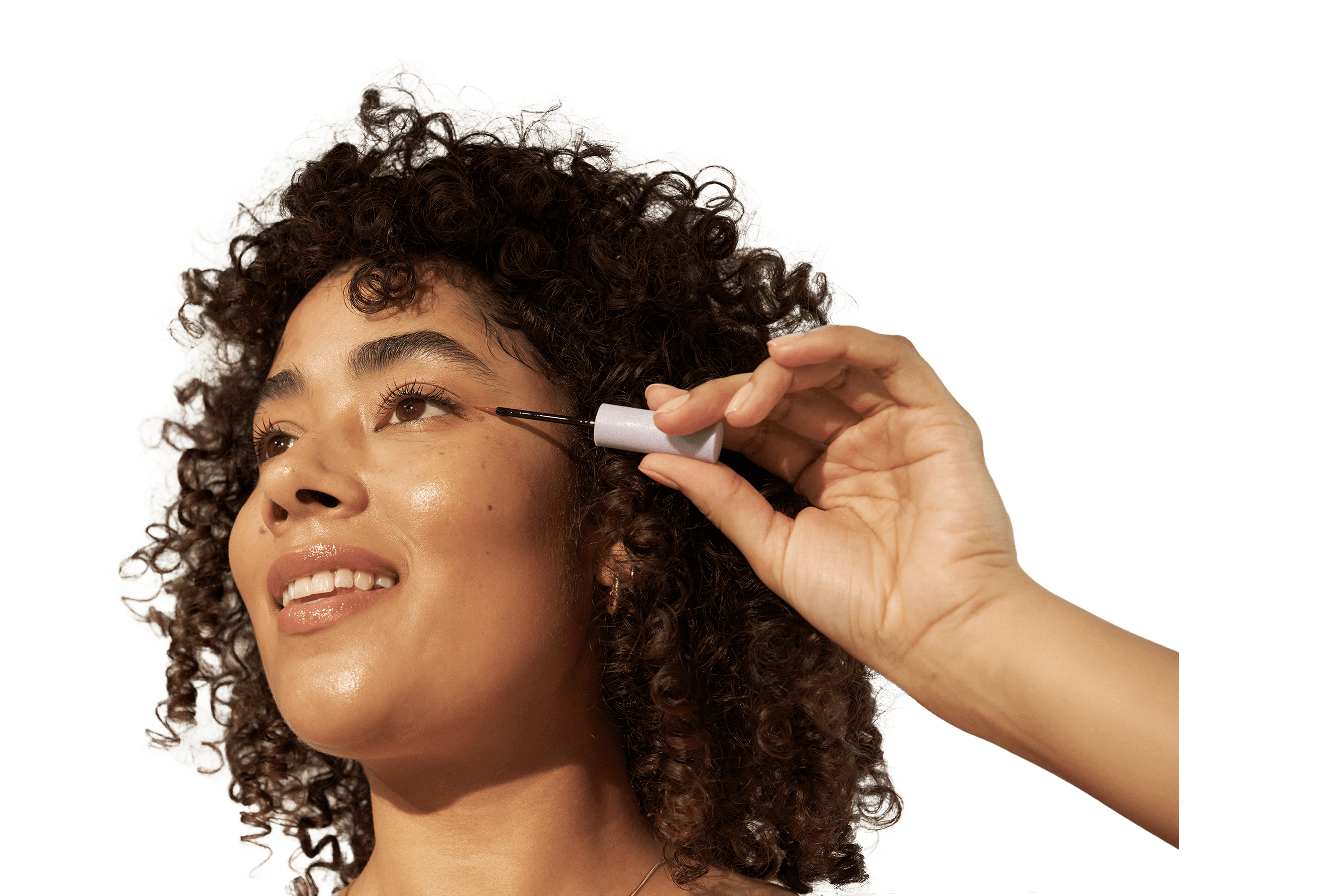 Woman applying eyelash enhancing serum