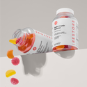 biotin gummies bottle beside and open biotin gummies bottle with gummies falling out