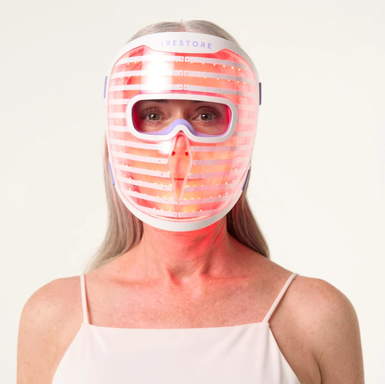 Woman wearing the iRESTORE LED face mask