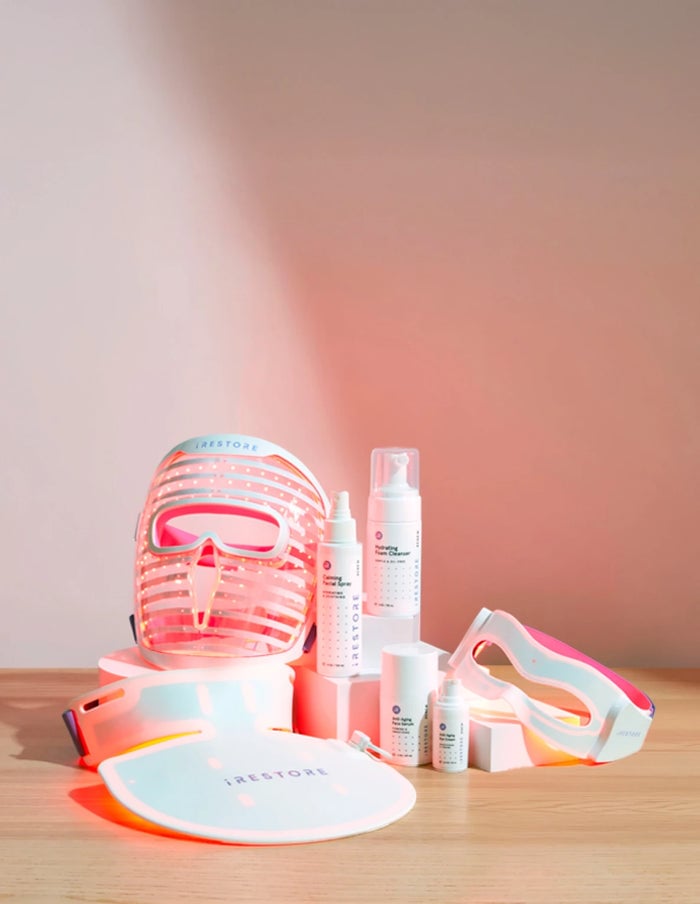 Illumina Face Mask, Eye Mask, Neck and Chest Mask and Red Light Essentials Kit all together on top of a table.