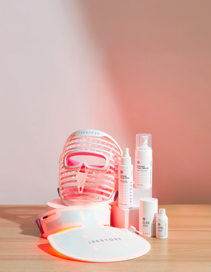 Face Mask device, Neck and Chest mask device and Red Light Essentials Kit all together on top of a table.