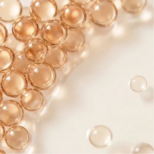 olden, translucent liquid beads suspended in a clear skincare serum
