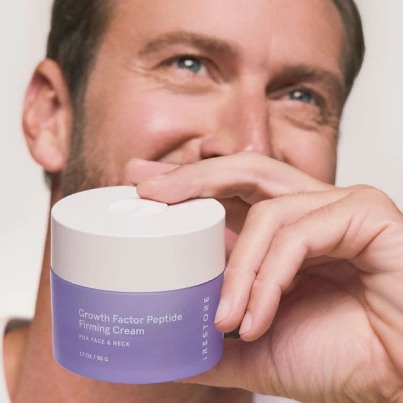 man holding a jar of the peptide cream