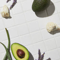 top view of Growth activator serum bottles laid on top of table together with some fruits and decorations