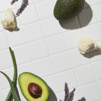 top view of Growth activator serum bottles laid on top of table together with some fruits and decorations