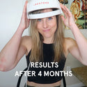 Woman showcasing the iRESTORE essential hair device