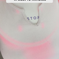 Woman showcasing how the iRESTORE led neck and chest mask can transform your skin in just ten minutes