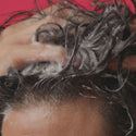 Short clip showing a male lathering a shampoo on his hair.
