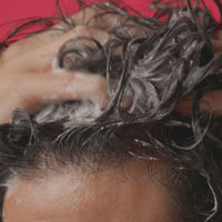 Short clip showing a male lathering a shampoo on his hair.